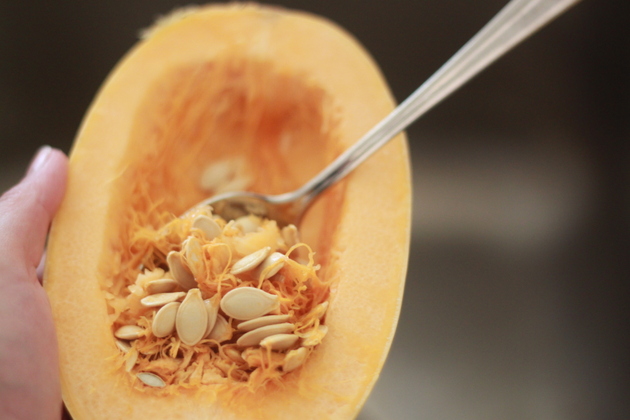 Scraping the seeds out of a spaghetti squash with a spoon
