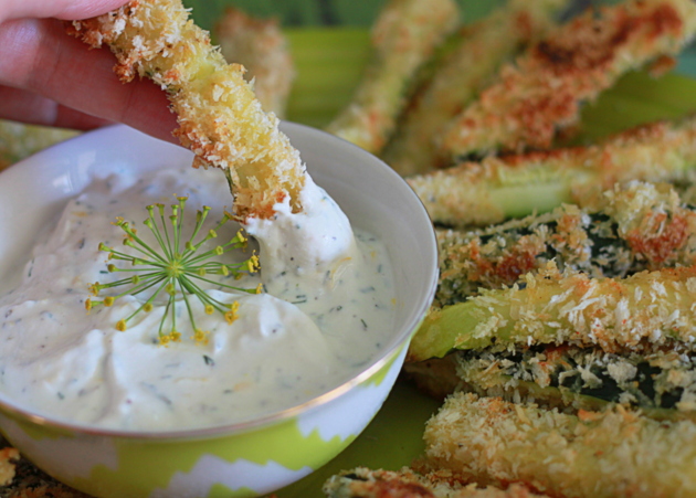 A baked zucchini fries dipped in a creamy yogurt dill sauce