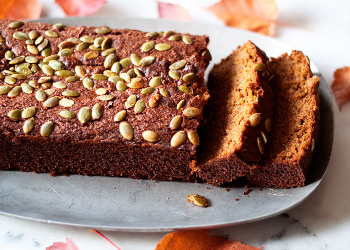 A loaf and slices of gluten-free pumpkin bread