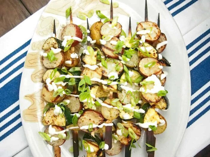 A platter of skewers with grilled potatoes and zucchini